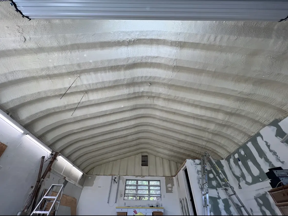 Spray polyurethane foam applied to the underside of a metal roof deck in Center Point